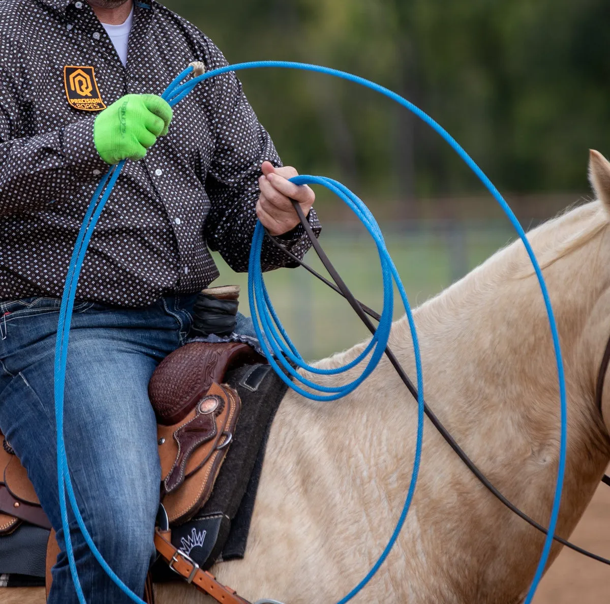 Blue Six Seals 6 rope held in a gloved hand on horseback